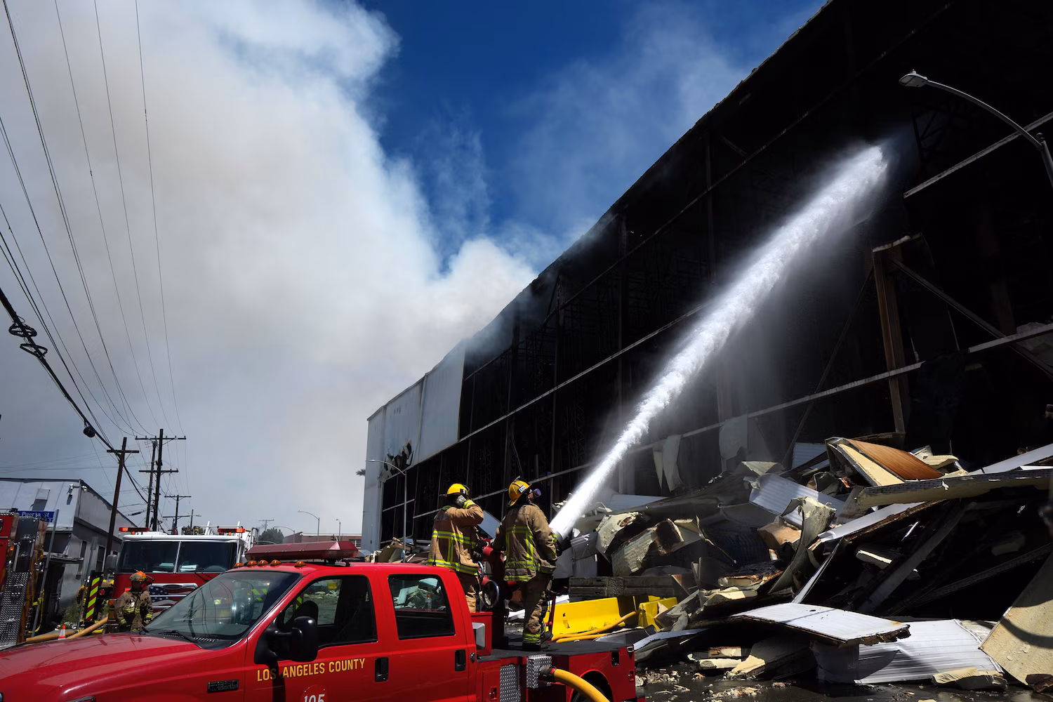 Massive Los Angeles warehouse fire continues to burn, prompting air quality warnings