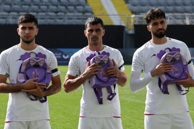 Iran footballers pay tribute to victims of school strike at start of war