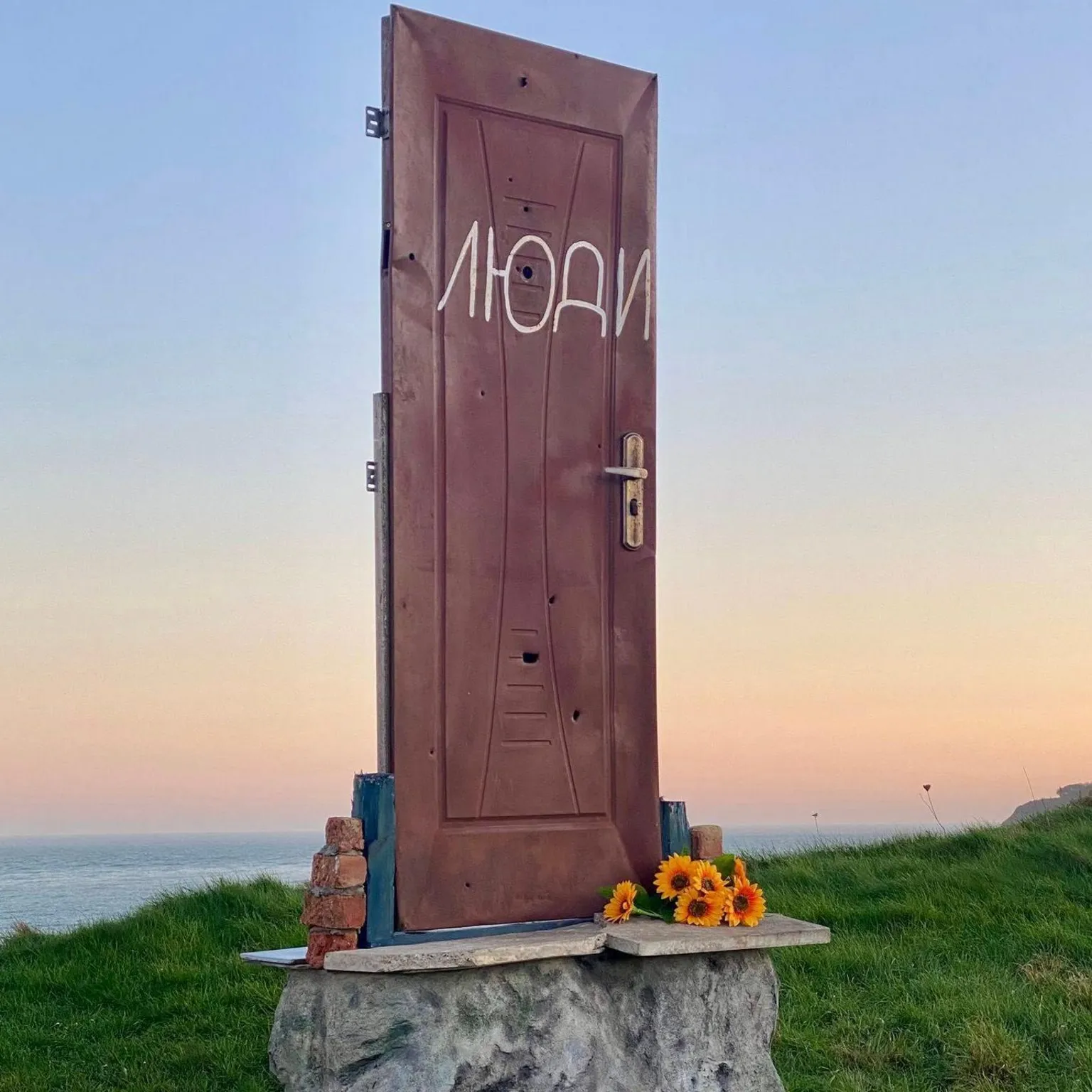 Artist's Ukrainian bulleted door displayed on hill