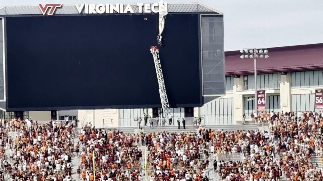 Skydiver rescued from scoreboard during spring football game