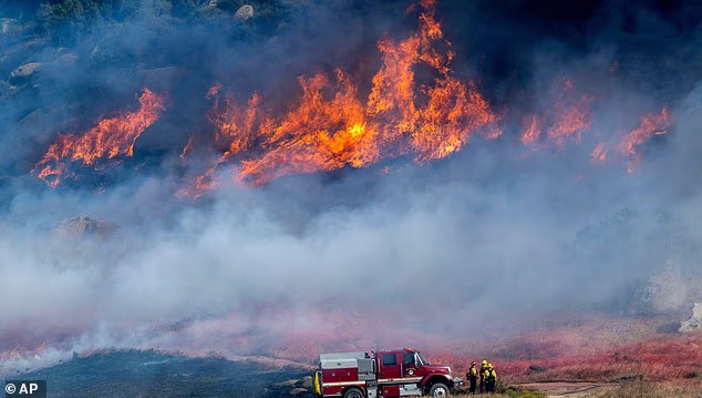 Thousands of Californians evacuated as Santa Ana winds fuel two fast-spreading wildfires