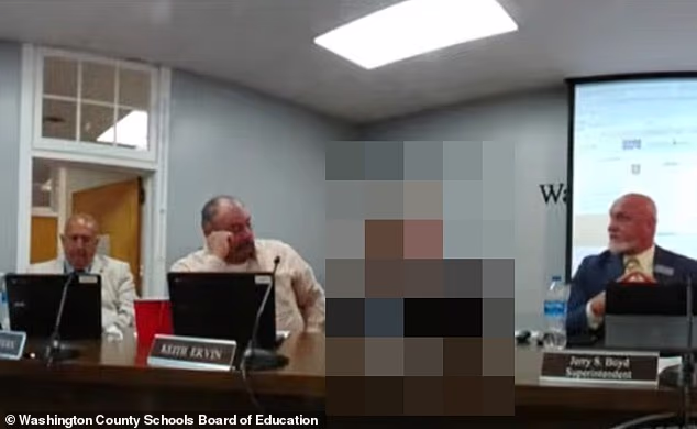 Disturbing moment middle-aged male school board member puts his arm around girl at public meeting and calls her 'HOT'