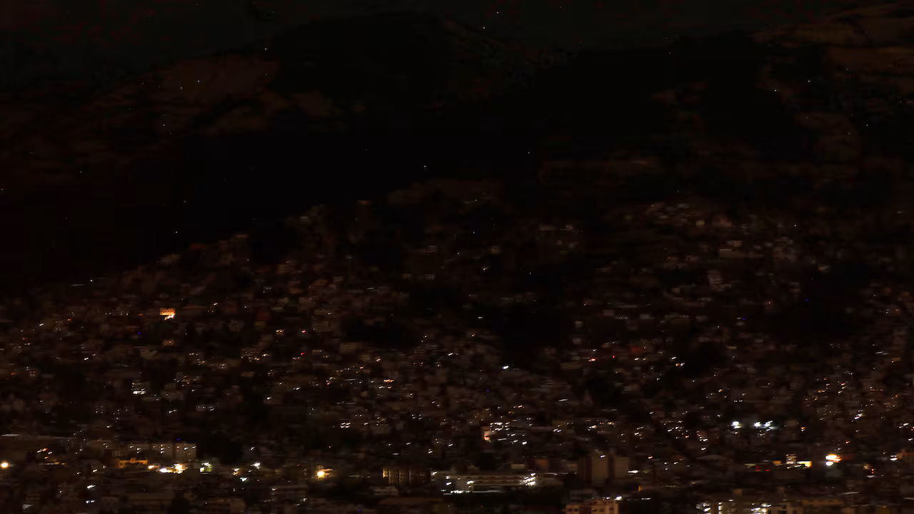 Vista parcial de la ciudad en oscuridad durante un racionamiento nacional programado de electricidad debido al mantenimiento del sistema de transmisión y redes de distribución, en