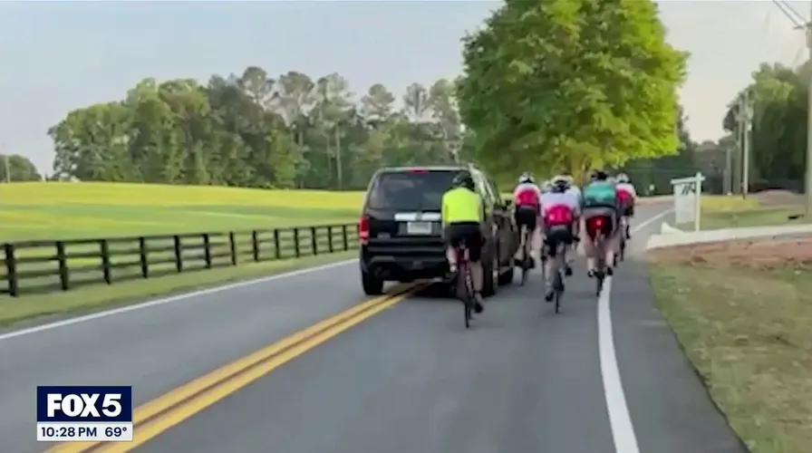WATCH: Driver smirks in mugshot after allegedly hitting group of cyclists in caught-on-camera road rage