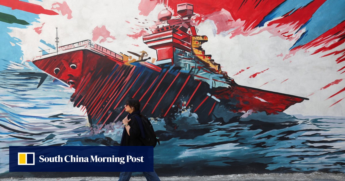 An Iranian woman walks next to an anti-US mural on a street in Tehran on Wednesday. Photo: West Asia News Agency via Reuters