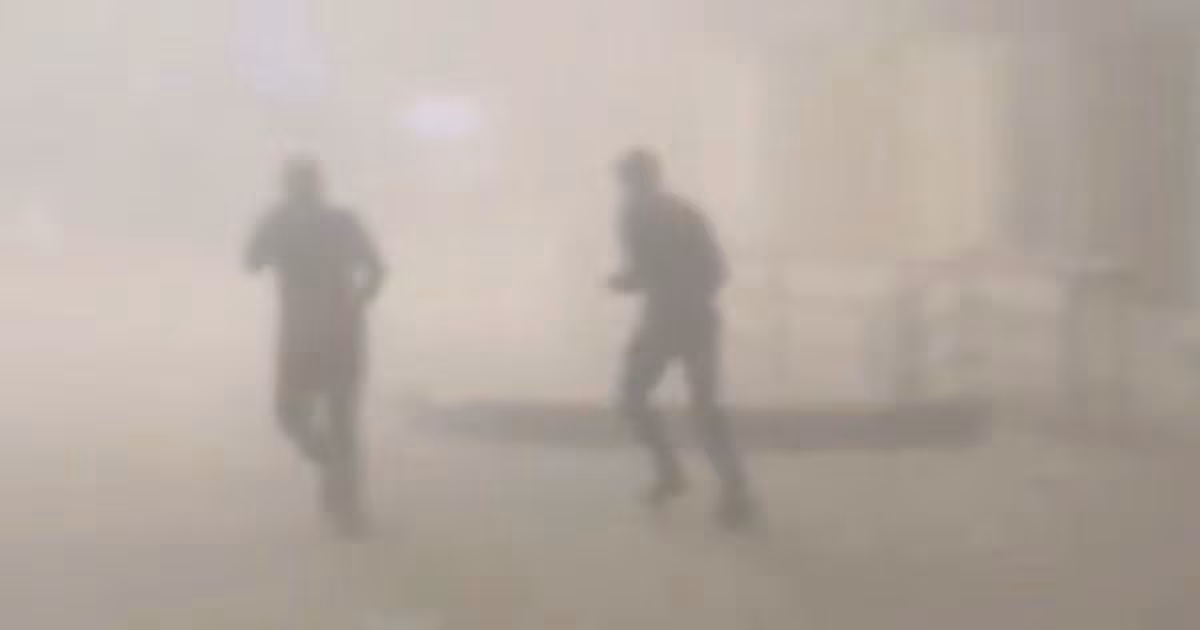 People run from a fire in the aftermath of Wednesday's Iranian strikes on Kuwait International Airport. Reuters