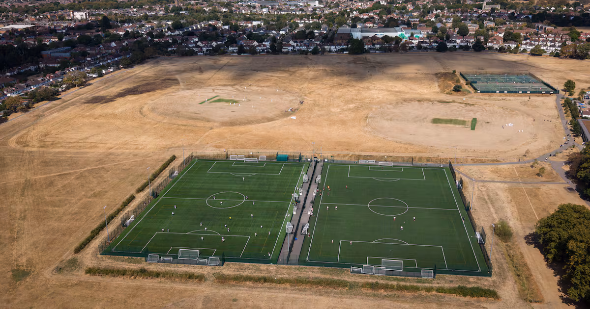 Football being played on synthetic surfaces alongside cricket matches on drought-damaged fields in Gunnersbury Park, London, on August 22, 2026. Getty Images
