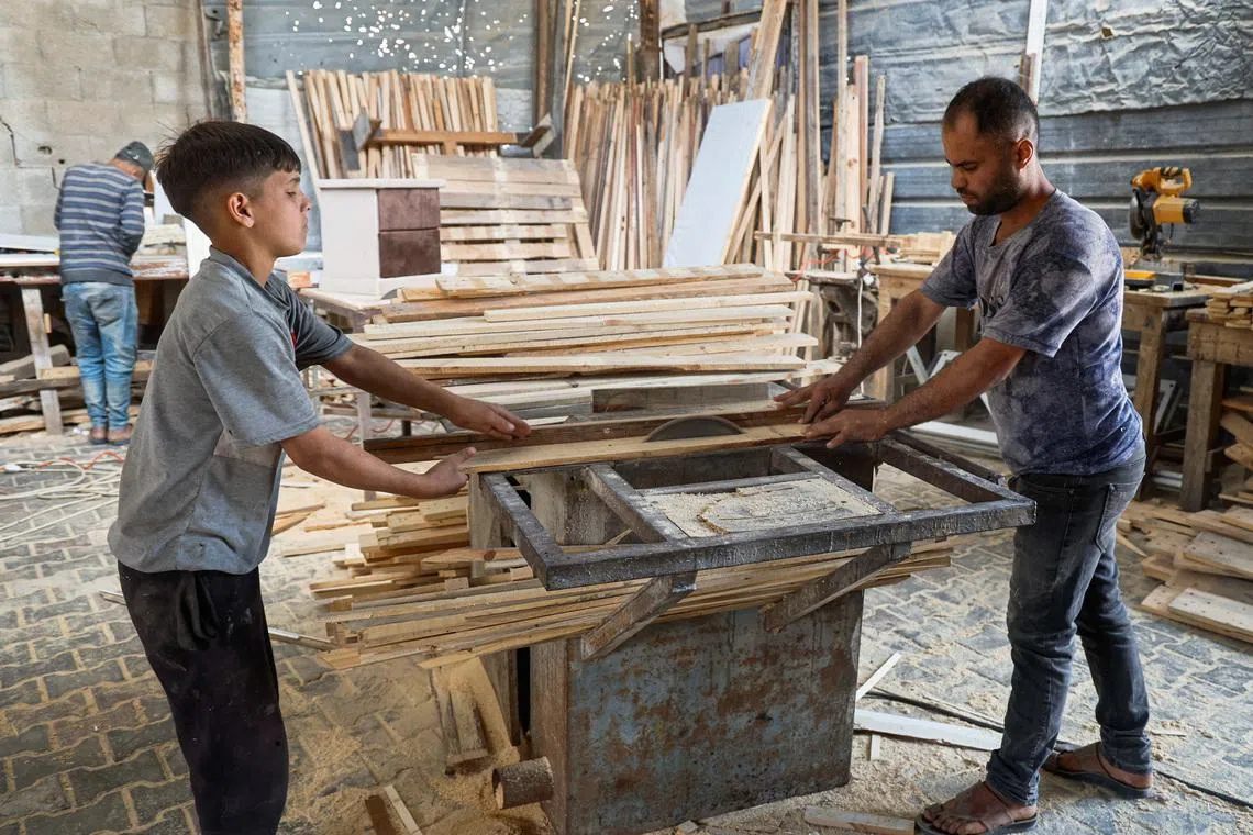 With wood scarce, Gaza carpenters turn to scraps and pallets to make simple beds