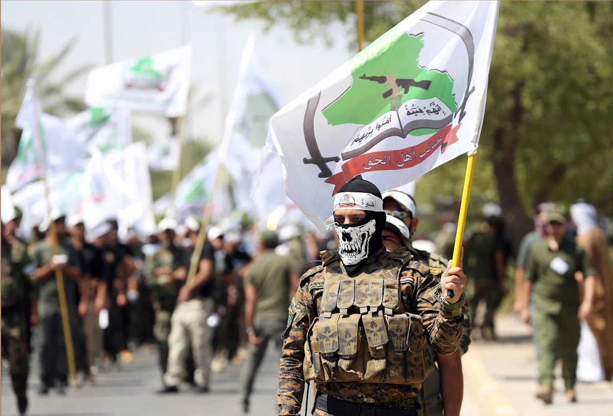Powerful Iran-backed Iraqi militia says it will start handing its weapons to the state
