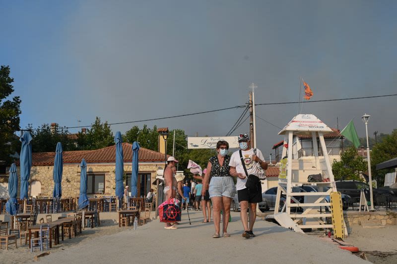 Tourists flee as Greek wildfire descends on resort village